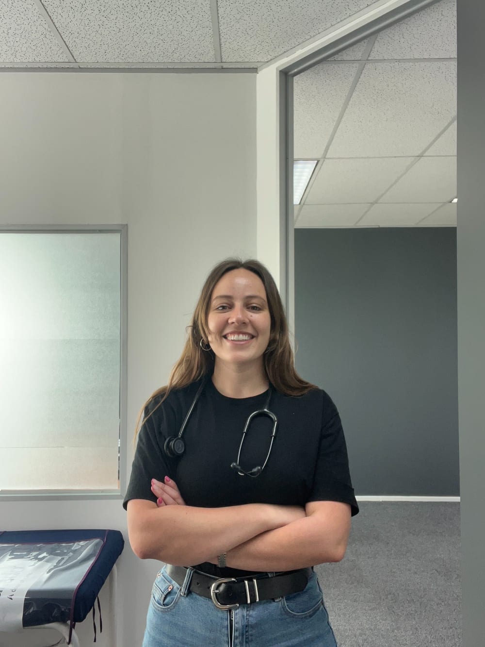Dr Olivia Visentin standing in her consulting room, wearing a stethoscope