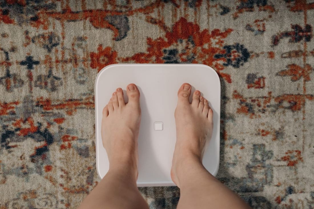 Feet on a bathroom scale, representing medical weight loss care