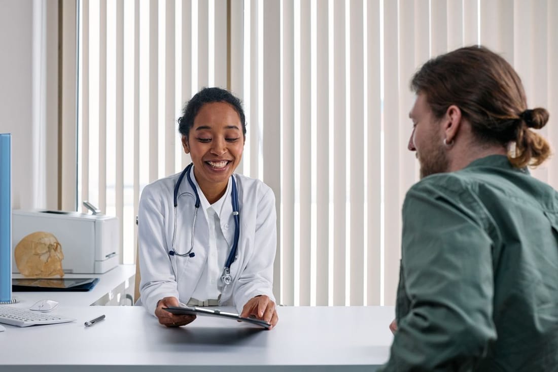 Doctor consulting with a male patient, representing men's health services