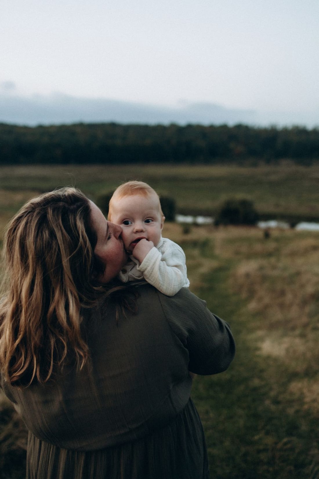 Parent holding a baby outdoors, representing paediatric health care